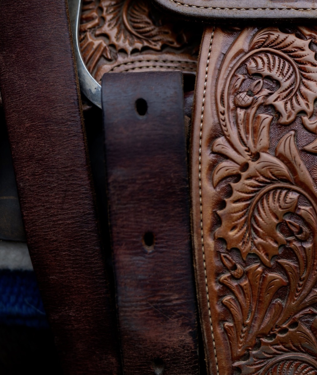 Close-up of hand-tooled western saddle leather with floral carving